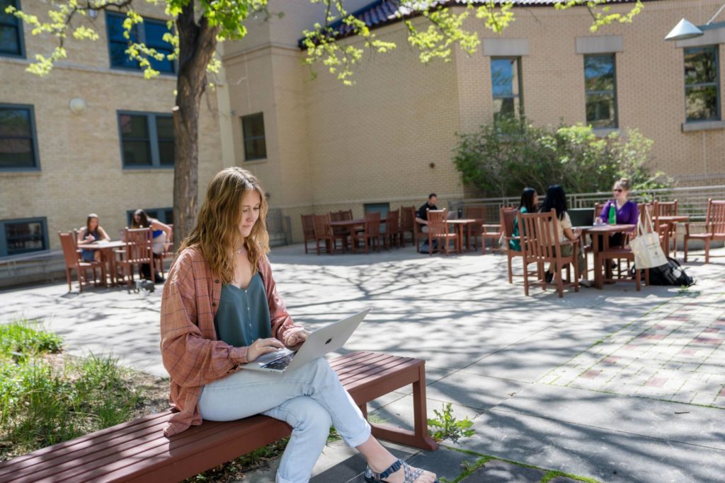 Student working on a computer outside at CSU Fort Collins